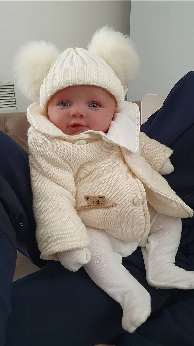 Carlo is registered to the contest to win money with this photo: baby, cheek, child, fur, head, headwear, person, product, skin, toddler, white, wool