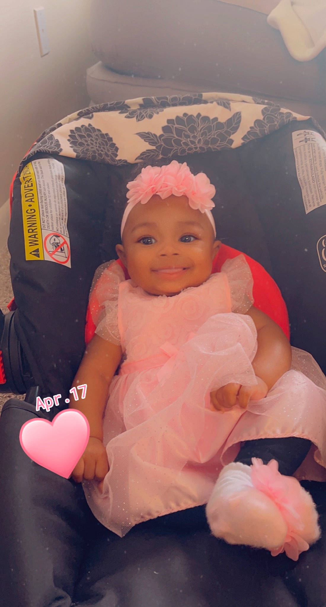 Sarai is registered to the contest to win money with this photo: arm, baby, baby_toddler_clothing, cheek, child, comfort, facial_expression, finger, fun, gesture, happy, headgear, headwear, human_body, joy, lap, mouth, person, pink, skin