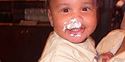 Dallas is registered to the contest to win money with this photo: apparel, baby, baseball_clothing, casual_clothing, celebration, child, cream_on_face, cute, face_paint, food_smear, happy, hat, indoor, joyful, messy_face, paper_hat, person_holding_child, portrait, smiling, toddler