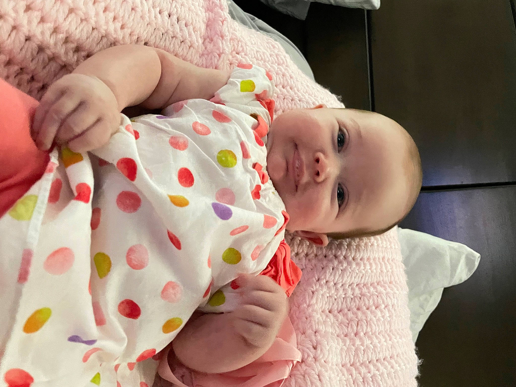 Hadley is registered to the contest to win money with this photo: baby, baby_toddler_clothing, cheek, child, comfort, dress, finger, hand, happy, hat, human_body, joy, lip, mouth, nose, person, pink, product, skin, sleeve