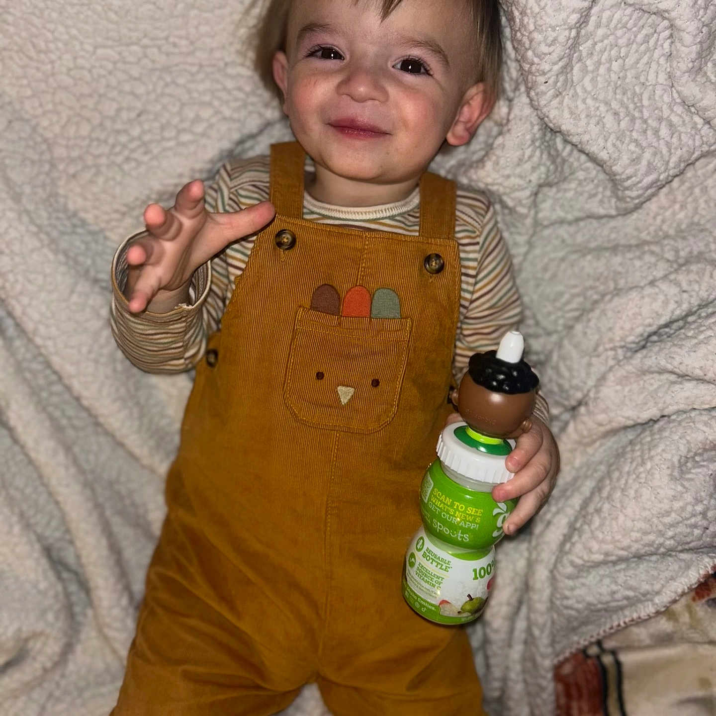 Carter is registered to the contest to win money with this photo: baby, bodypart, bottle, clothing, coat, face, finger, furniture, hand, happy, head, herbal, jacket, jeans, pants, person, photography, portrait, shorts, smile