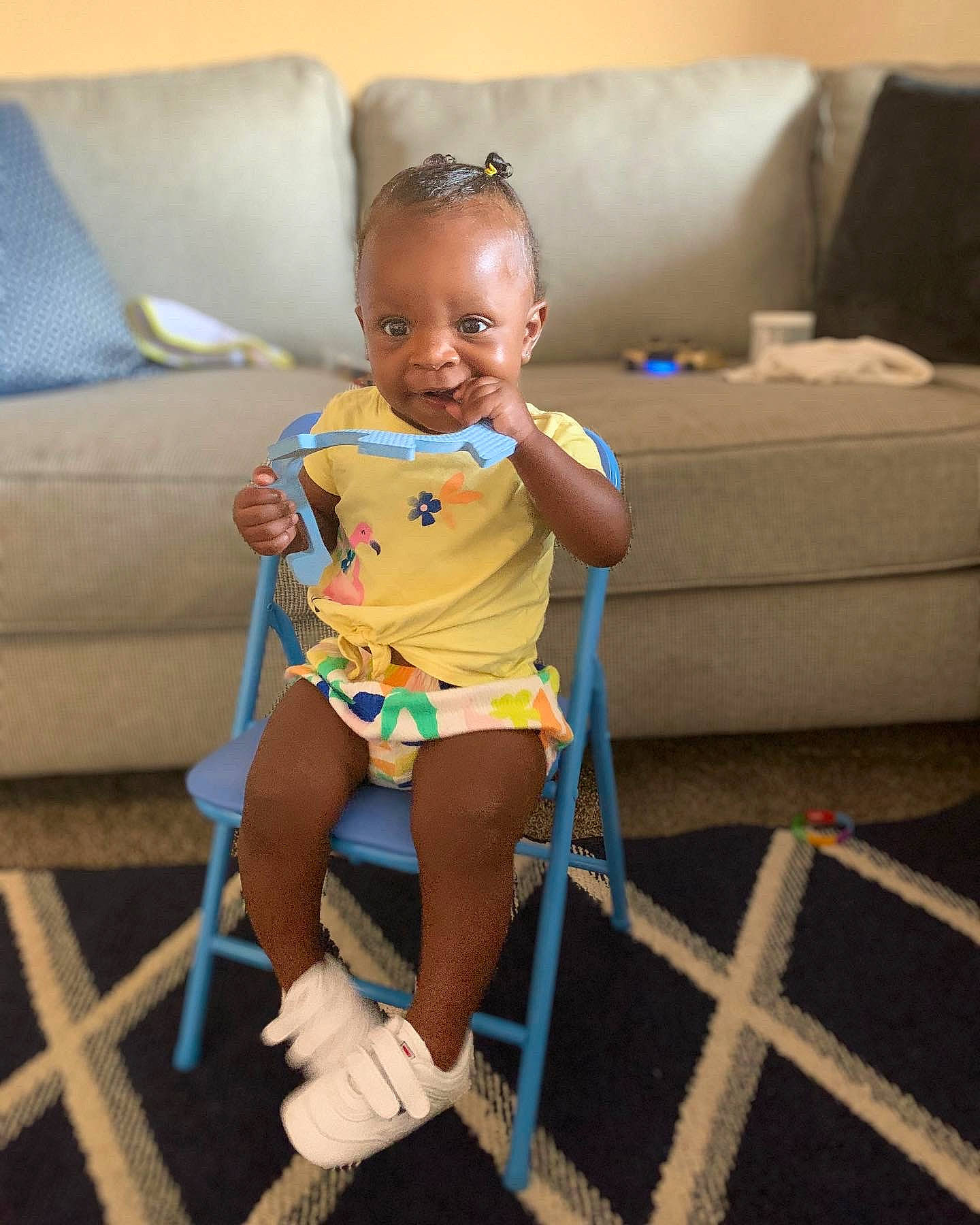 Khailani is registered to the contest to win money with this photo: baby, baby_toddler_clothing, barefoot, child, couch, face, fun, head, human_body, human_leg, joint, knee, leg, leisure, person, shipping_box, skin, smile, thigh, toddler