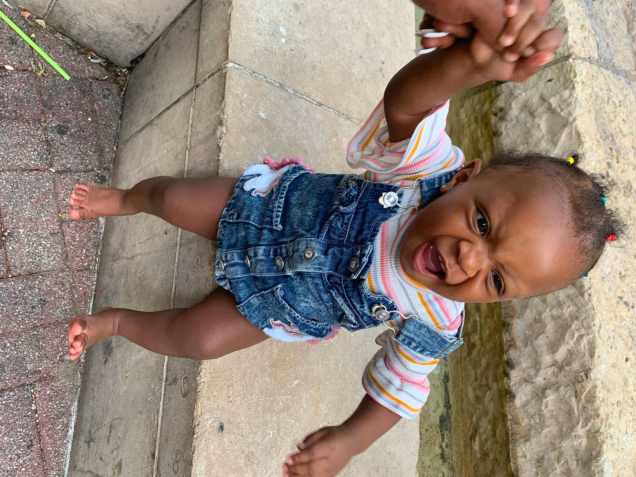 Khailani is registered to the contest to win money with this photo: anger, arm, chin, elbow, finger, fun, hand, happy, head, human_body, joint, leg, leisure, people_in_nature, person, public_space, skin, smile, standing, temple