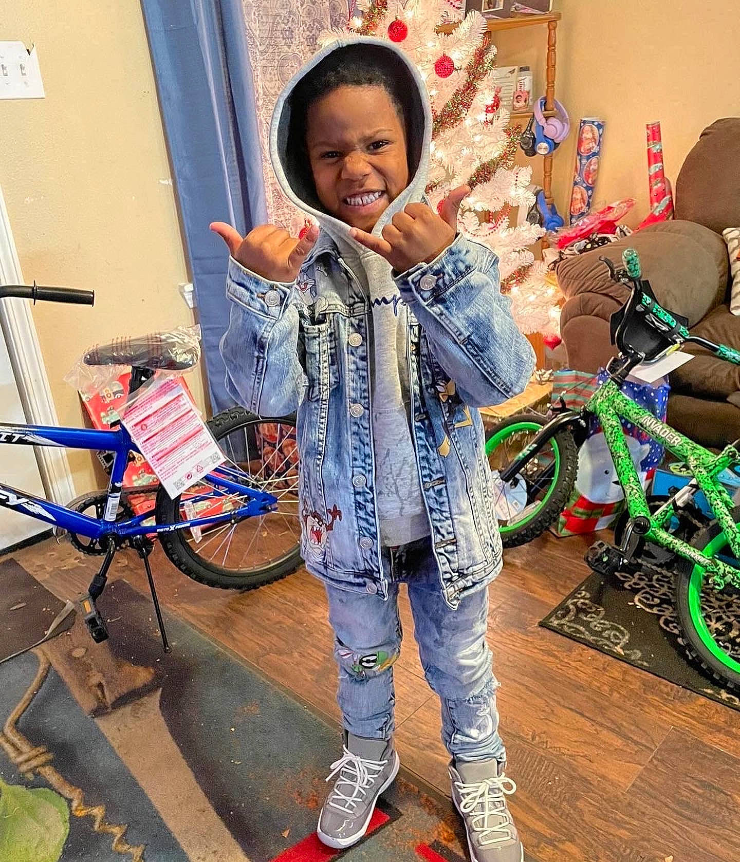 Princeton is registered to the contest to win money with this photo: bag, bicycle_frame, bicycle_handlebar, bicycle_tire, bicycle_wheel, chair, child, curtain, electric_blue, fashion_design, flooring, happy, helmet, holiday, people, person, sitting, sleeve, smile, tire