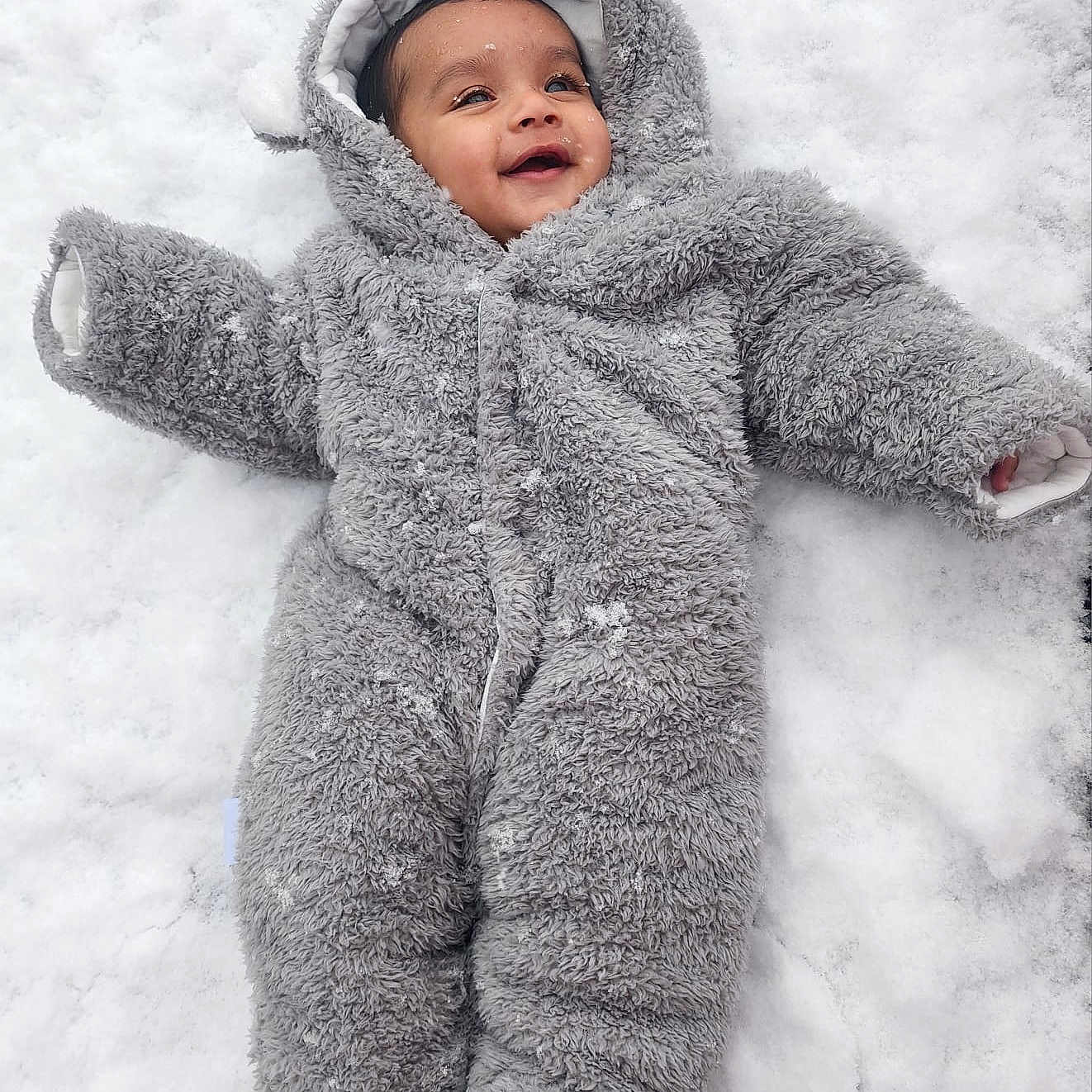 Aryan joined the competition — help win amazing prizes! baby, babylaughing, blanket, clothing, coat, face, happy, head, hood, jacket, knitwear, nature, outdoors, person, photography, portrait, snow, snowangel, sweater, winter