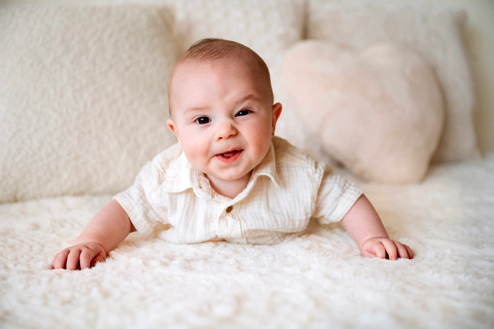 Matthew joined the competition — help win amazing prizes! baby, infant, smiling, face, shirt, lying_down, pillow, heart_shaped_pillow, white, soft_texture, indoors, cute, child, portrait, happy, skin, hands, head, expression, cozy