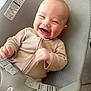Matthew is registered to the contest to win money with this photo: baby, infant, smiling, laughing, onesie, beige_clothing, baby_seat, mesh_fabric, safety_harness, happy, cute, child, indoor, portrait, human, seat, straps, baby_furniture, light, close_up