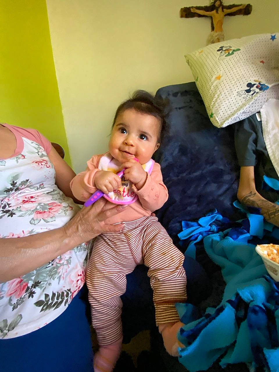 Celina joined the competition — help win amazing prizes! baby, child, cross, event, fun, gesture, happy, joy, leisure, nail, party, person, pillow, play, religious_item, room, sitting, smile, symbol, thumb