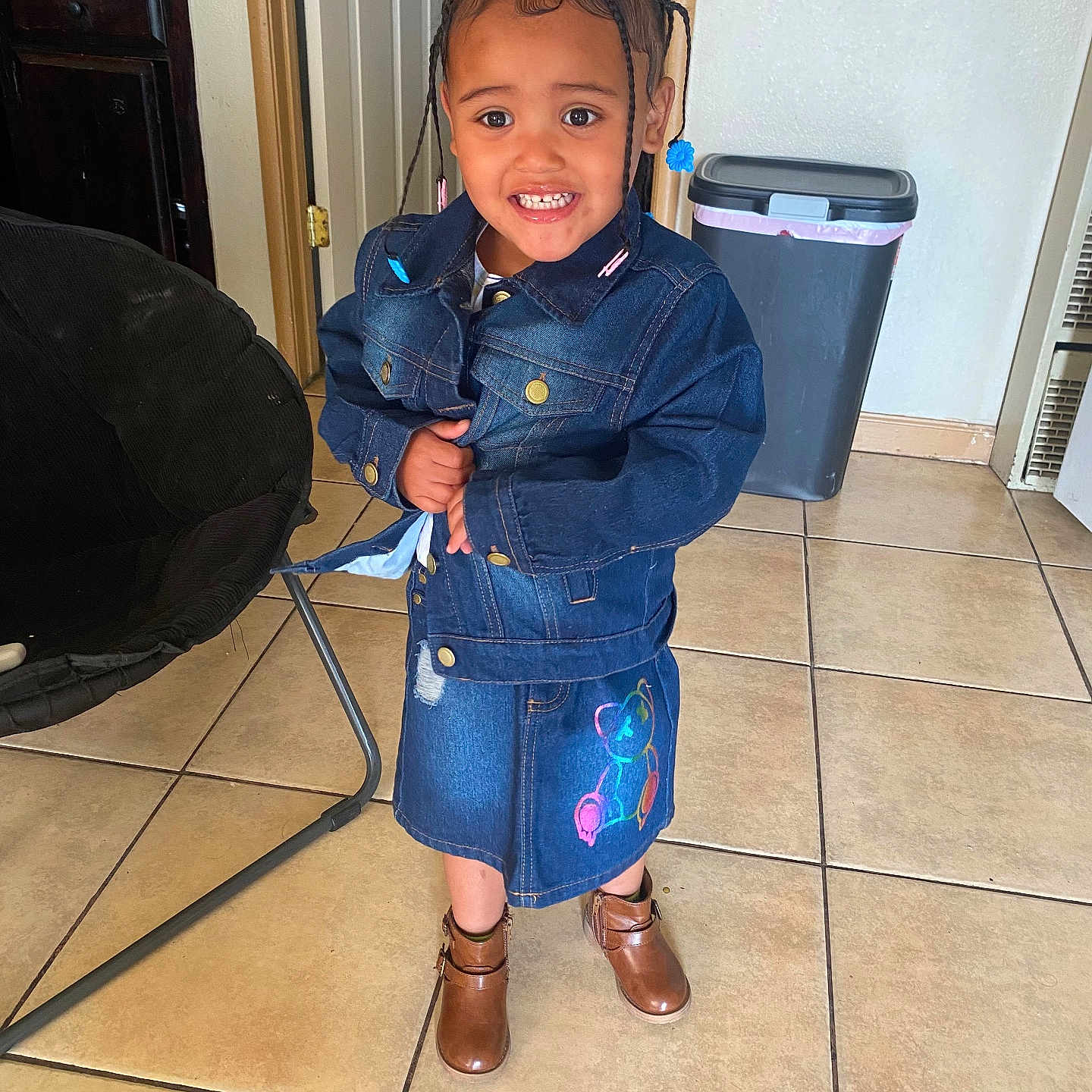 Miracle is registered to the contest to win money with this photo: child, clothing, coat, door, face, female, footwear, girl, head, jacket, jeans, pants, person, photography, plant, portrait, pottedplant, sandal, shoe, shorts