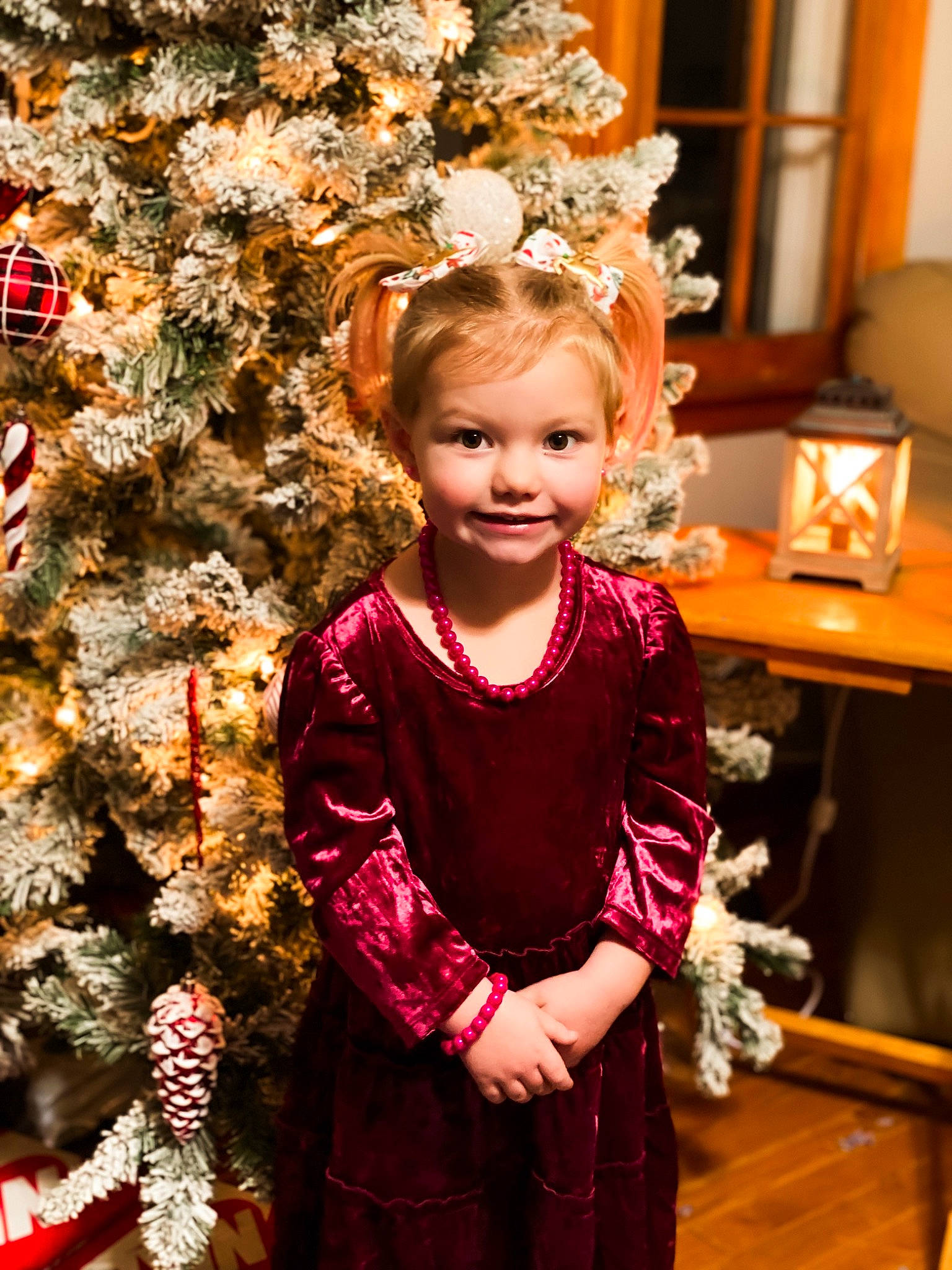 Blake-lynn is registered to the contest to win money with this photo: christmas_decoration, christmas_ornament, christmas_tree, dress, event, eye, fun, hair, happy, headgear, human_body, iris, joy, lamp, ornament, person, pink, plant, sleeve, smile