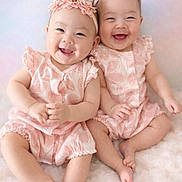 Molly And Mira joined the competition — help win amazing prizes! adorable, babies, baby_photography, blanket, children, cuddling, family, flower_headbands, fluffy_blanket, happy, indoor, infants, joyful, matching_outfits, pink, portrait, sitting, smiling, soft_lighting, twins