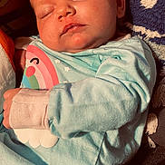 River joined the competition — help win amazing prizes! baby, sleeping, infant, blue_clothing, rainbow, cloud, blanket, cushion, face, hand, cozy, soft_texture, closeup, indoors, peaceful, child, newborn, portrait, nap, warm_lighting