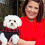 Ziggy is registered to the contest to win money with this photo: woman, dog, pet, smile, red_blouse, white_dog, fluffy, plaid_sweater, holding, outdoor, portrait, happy, fashion, accessories, earrings, hair_clip, hand, cuddly, cute, winter