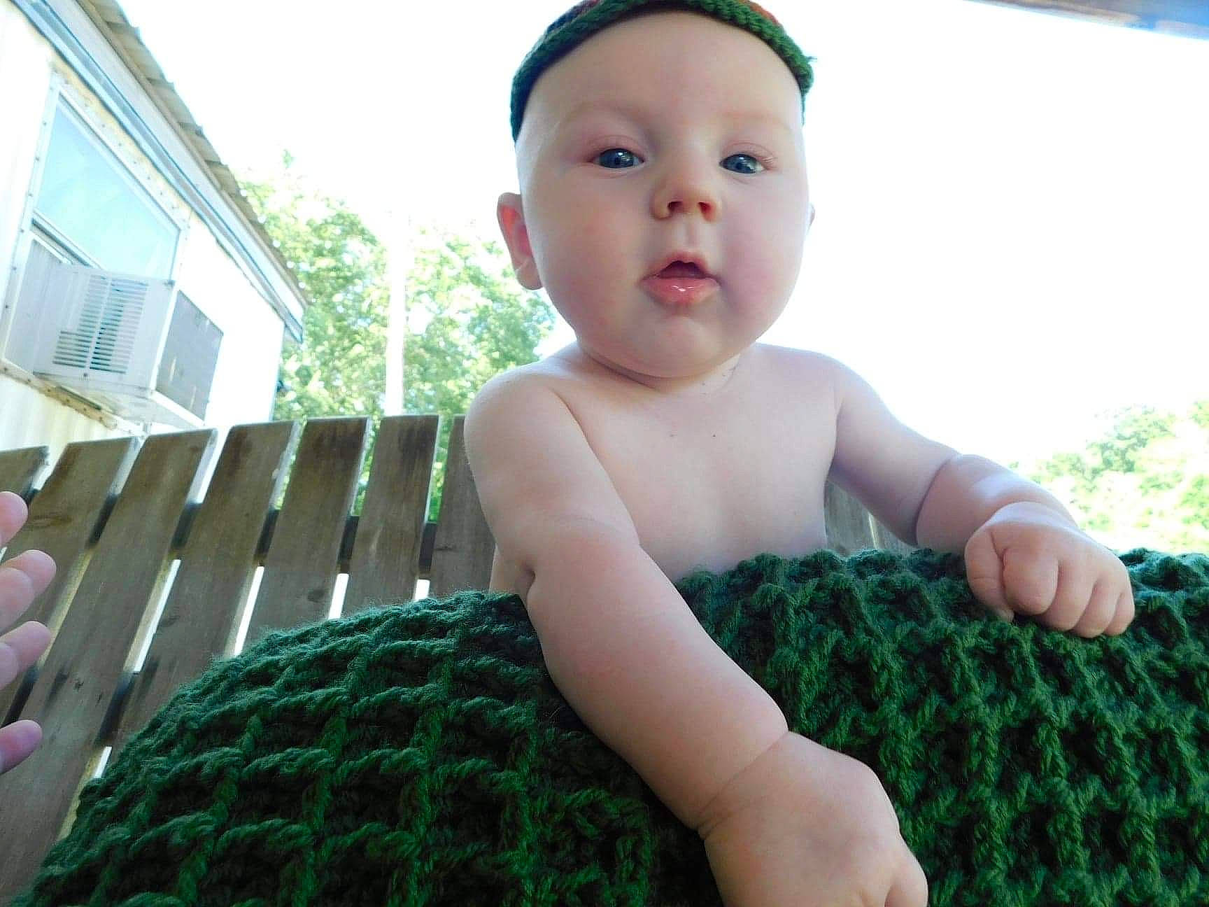 Rowin is registered to the contest to win money with this photo: arm, azure, baby, baby_toddler_clothing, finger, grass, green, hand, happy, human_body, leg, mammal, muscle, organ, person, photograph, plant, product, skin, thumb