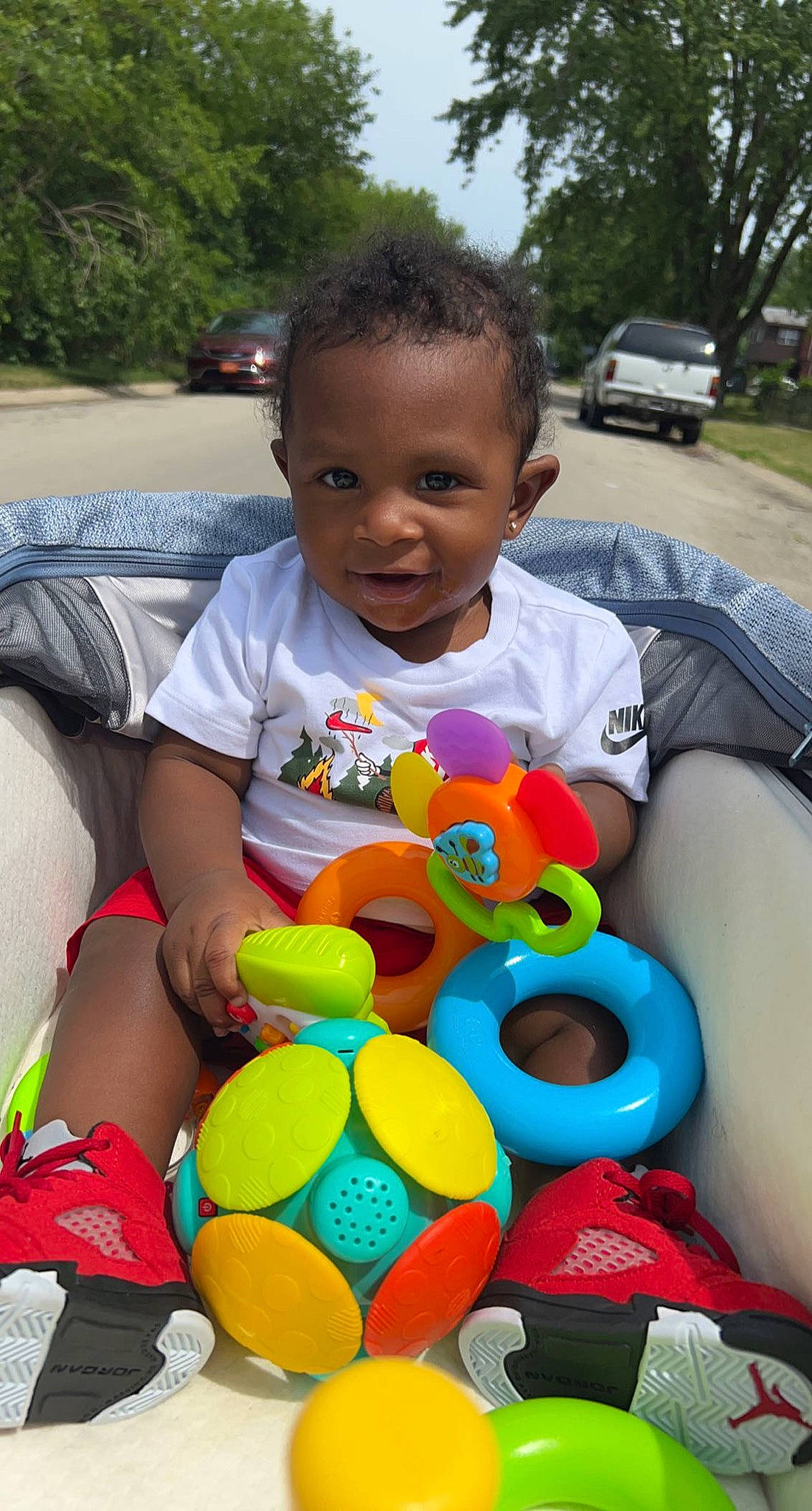 Zamir is registered to the contest to win money with this photo: automotive_wheel_system, baby, baby_toddler_clothing, car, child, fun, grass, happy, head, leisure, person, plant, recreation, smile, summer, t_shirt, tire, toddler, toy, tree