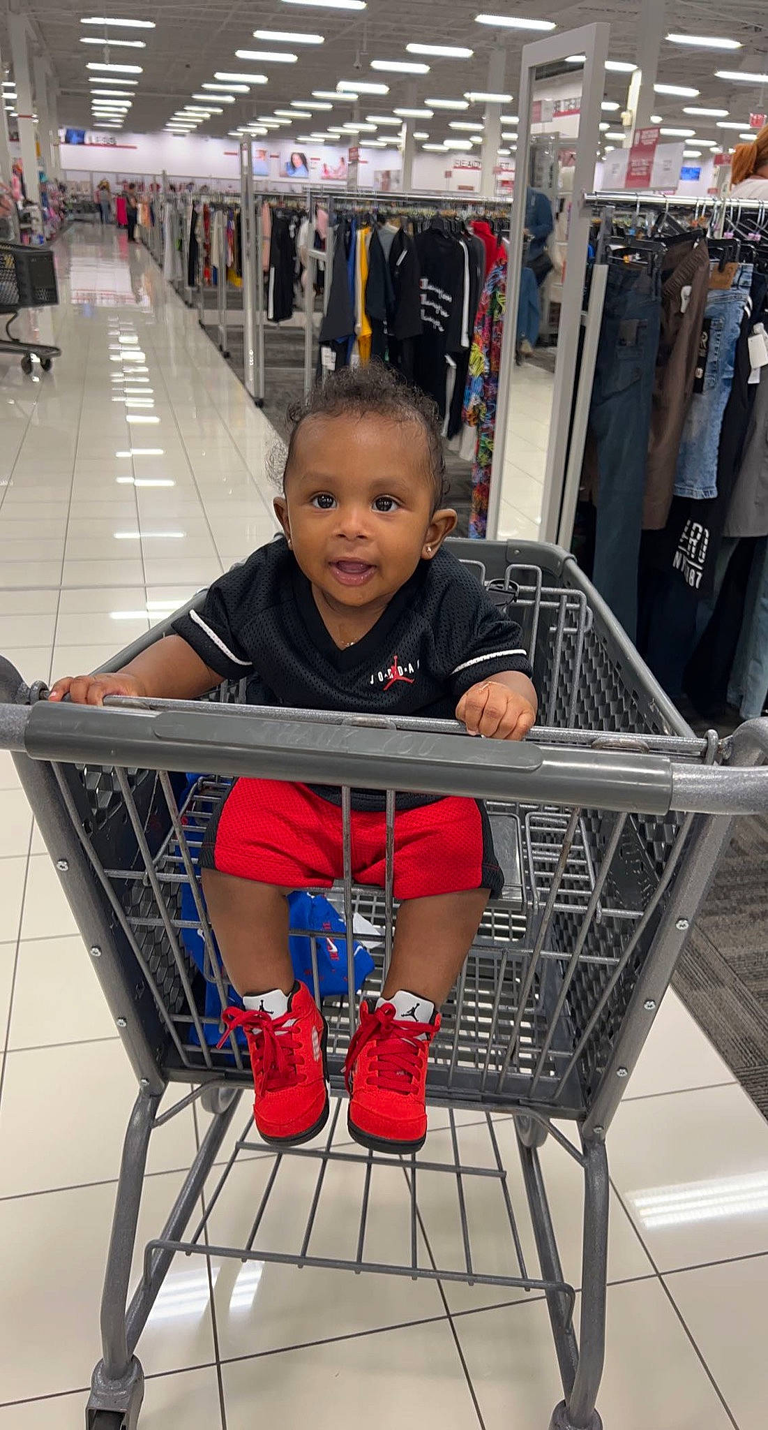 Zamir is registered to the contest to win money with this photo: chair, child, customer, fun, human_leg, leg, leisure, person, red, retail, service, shelf, shopping, shopping_cart, shorts, smile, snapshot, t_shirt, thigh, tire