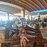 architecture, bench, ceiling, children, cute, decor, family, happy, hippo, hugging, indoor, light, plants, playful, public_space, sculpture, siblings, smiling, stone_wall, wooden_bench