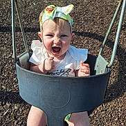 Brooklynn joined the competition — help win amazing prizes! baby, toddler, child, swing, playground, headband, bow, expression, outdoor, sunlight, fun, happy, seat, clothing, summer, play, person, smile, cute, joy