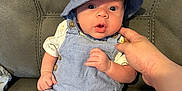 Sorley joined the competition — help win amazing prizes! baby, blue_clothing, child, couch, cute, expression, furniture, hand, hat, indoor, infant, leather, overalls, person, portrait, sitting, skin, support, wide_eyes, young