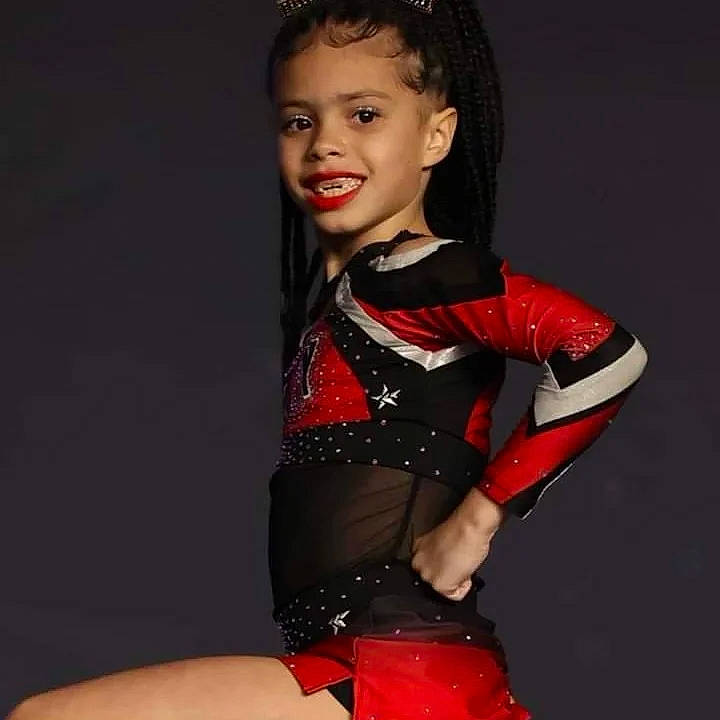Aubrey is registered to the contest to win money with this photo: abdomen, art, black_hair, carmine, entertainment, event, fashion_design, flash_photography, glove, human_leg, jewellery, joy, leotard, performing_arts, person, sleeve, smile, sportswear, thigh, toy