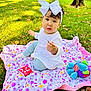 toddler, child, baby, bow, blanket, grass, leaf, toy, elephant_toy, outdoor, park, sunlight, fall, nature, cute, playtime, sitting, colorful, happy, young_child