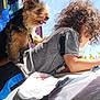 Teddy is registered to the contest to win money with this photo: dog, child, bed, window, curtains, sunlight, indoor, blue_sky, curly_hair, collar, pet, animal, casual_clothing, resting, looking_outside, colorful, happy, young, playful, cozy