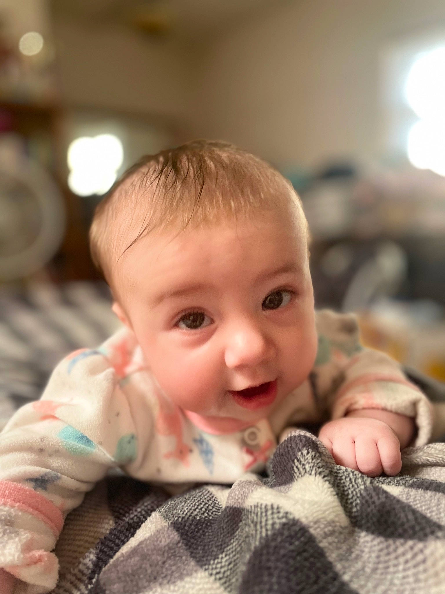 Malia joined the competition — help win amazing prizes! baby, baby_toddler_clothing, cheek, child, comfort, finger, flash_photography, flooring, fun, fur, happy, head, human, linens, person, sitting, skin, smile, toddler, tummy_time