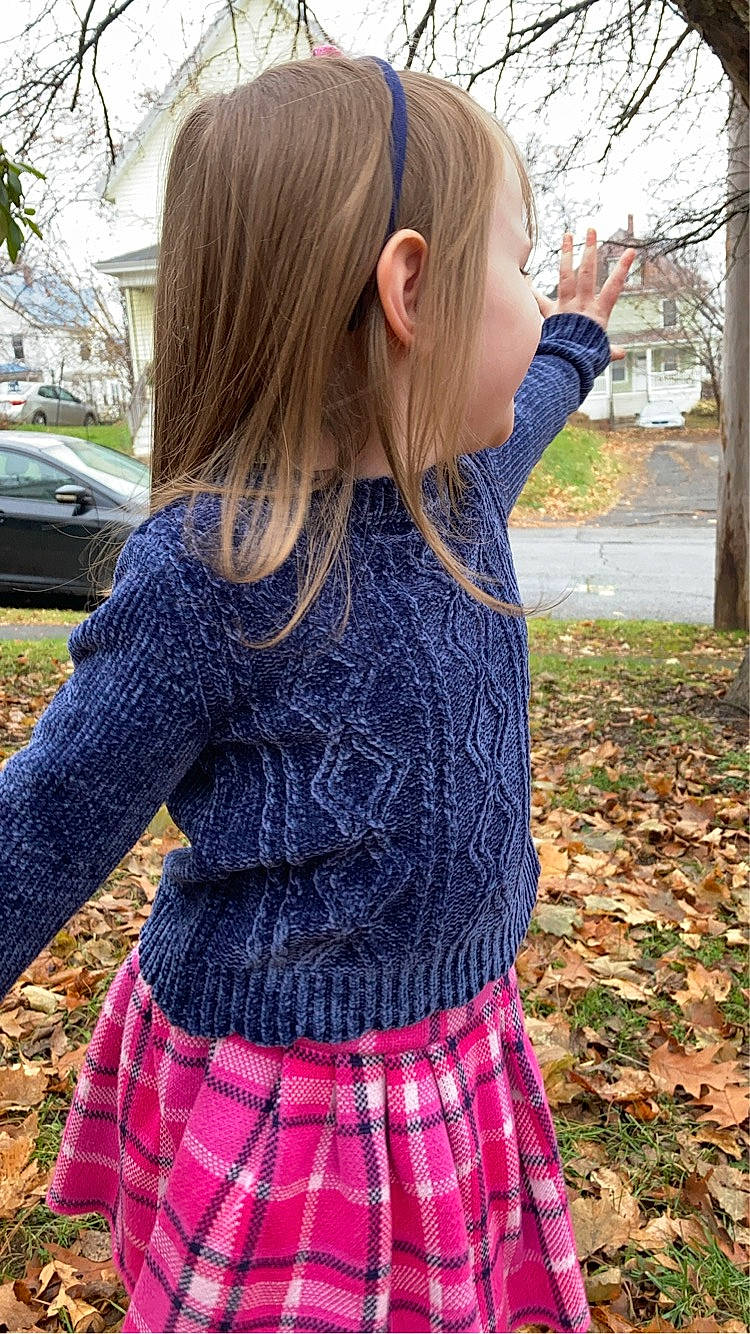 Neveah is registered to the contest to win money with this photo: blond, denim, electric_blue, grass, hair, magenta, pattern, person, pink, plaid, plant, purple, shoulder, sleeve, t_shirt, tartan, textile, tire, tree, violet