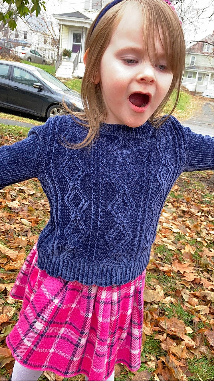 Neveah is registered to the contest to win money with this photo: car, cool, dress, eye, fashion, grass, hairstyle, happy, outerwear, person, pink, plaid, plant, sleeve, summer, surprise, t_shirt, tartan, textile, tire