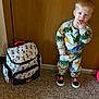 Tobias joined the competition — help win amazing prizes! toddler, child, dinosaur_pajamas, mickey_mouse, backpack, indoor, carpet, wooden_door, shoes, standing, curious_expression, hand_in_mouth, clothing, person, young_child, cute, casual, footwear, colorful, playful
