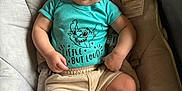 Bradlee joined the competition — help win amazing prizes! baby, pacifier, toddler, clothing, shirt, shorts, cushion, seat, infant, smile, child, indoors, cute, skin, legs, sitting, comfort, young, person, blue_shirt