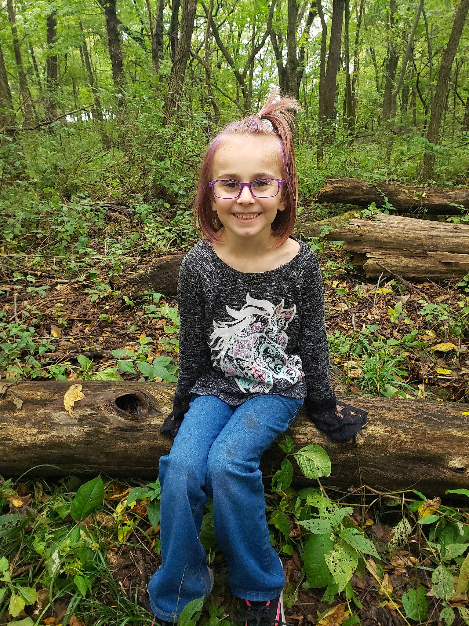 Temperance is registered to the contest to win money with this photo: botany, forest, grass, joy, jungle, leaf, natural_environment, natural_landscape, old_growth_forest, people_in_nature, person, photography, plant, rainforest, sitting, smile, terrestrial_plant, tree, trunk, valdivian_temperate_rain_forest