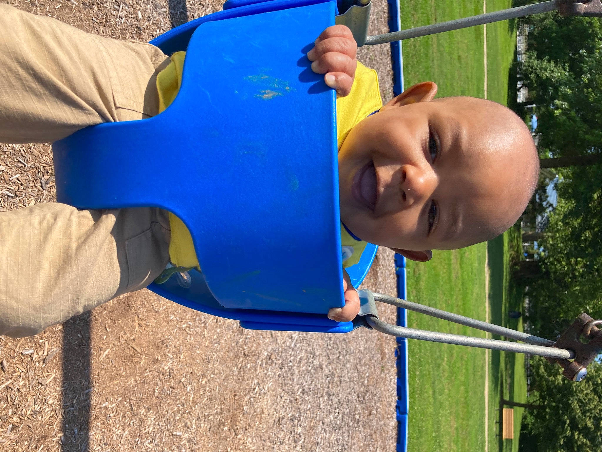 Marvel is registered to the contest to win money with this photo: blue, child, chute, city, electric_blue, fun, grass, happy, leisure, outdoor_play_equipment, person, play, playground, playground_slide, recreation, smile, swing, t_shirt, toddler, tree