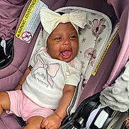 Chamyah joined the competition — help win amazing prizes! baby, infant, child, smiling, happy, portrait, car_seat, bow, headband, white_shirt, pink_shorts, clothing, floral_pattern, vehicle, automobile, indoor, seated, gummy_smile, safety_label, photography