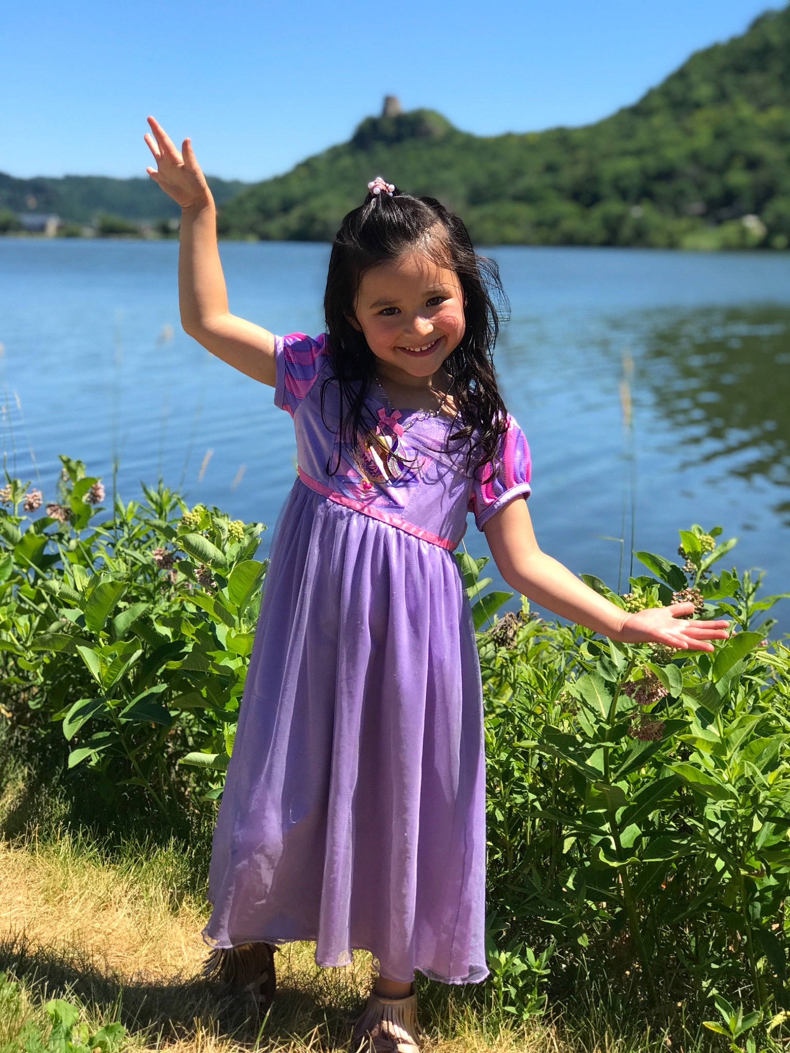 Brianna is registered to the contest to win money with this photo: botany, day_dress, dress, fun, grass, grassland, happy, joy, lake, leisure, meadow, nature, people_in_nature, person, plant, sky, sleeve, toddler, travel, tree