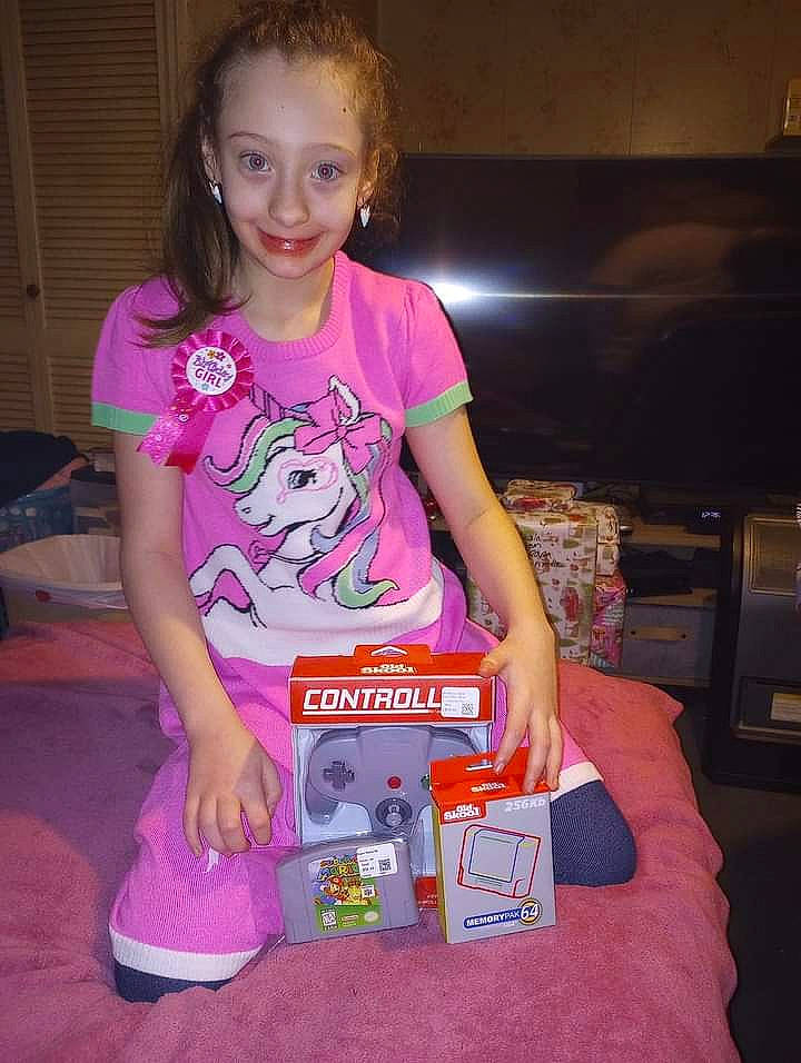 Mikeala joined the competition — help win amazing prizes! birthday, box, child, event, fun, joy, lap, magenta, nail, person, pink, recreation, shorts, sitting, smile, t_shirt, thigh, top