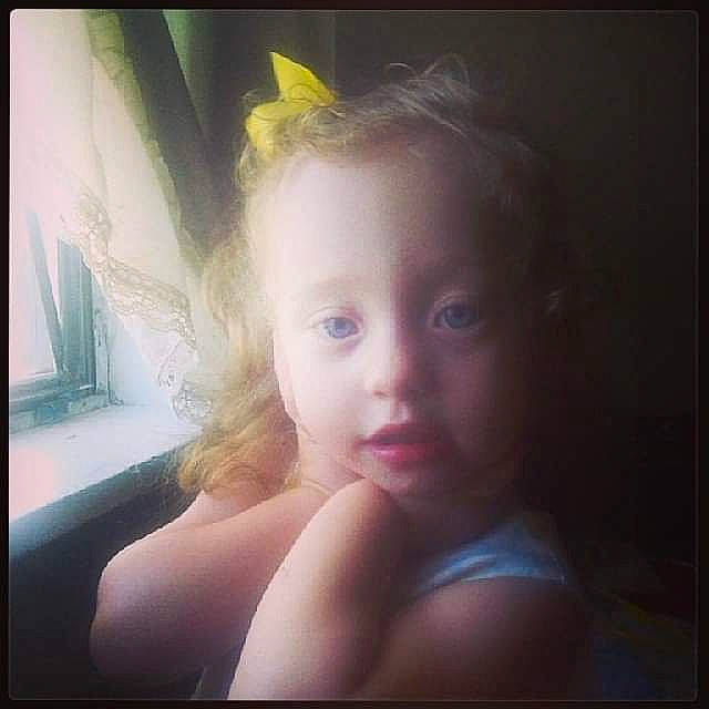 Mikeala is registered to the contest to win money with this photo: blond, brown_hair, cheek, chest, ear, eyebrow, eyelash, flash_photography, fun, happy, human_body, iris, lip, long_hair, neck, nose, person, sitting, smile, toddler