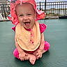 baby, child, smiling, happy, pink_clothing, sun_hat, outdoor, trampoline, fence, playful, cute, sitting, infant, young_child, joy, fun, summer, daylight, expression, portrait