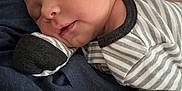 Everett is registered to the contest to win money with this photo: arm, baby, closed_eyes, cozy, cute, face, head, indoor, infant, newborn, newborn_clothes, peaceful, person, portrait, resting, skin, sleeping, soft_lighting, striped_clothing, tattoo