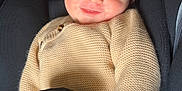 Maël participe au concours pour gagner de l'argent avec cette photo : baby, car_seat, child, clothing, comfort, cute, fingers, happy, indoors, infant, knitted_sweater, portrait, resting, safety, seat, seatbelt, smile, soft_toys, yellow_socks, young