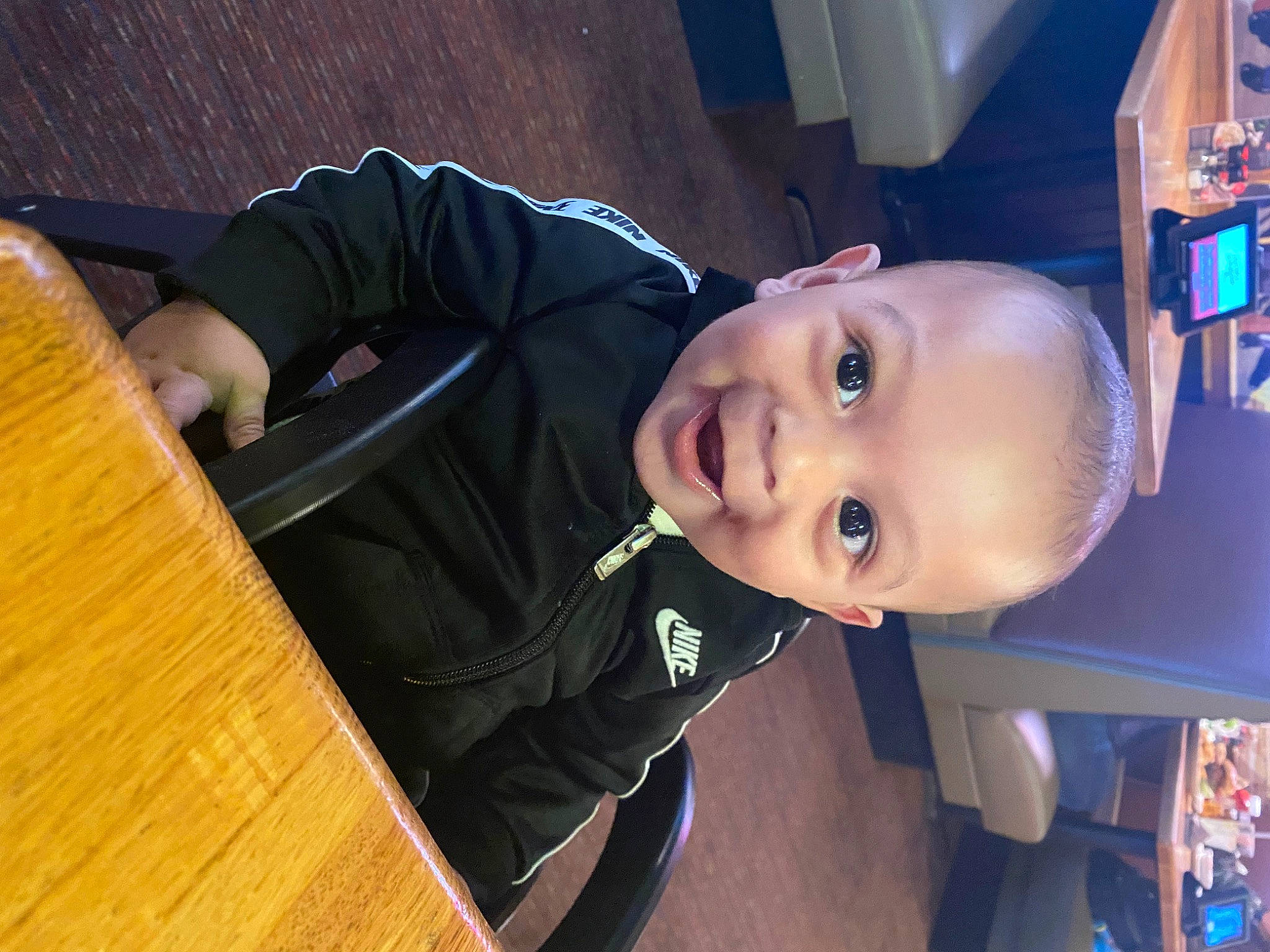 Jamal is registered to the contest to win money with this photo: baby, baby_products, baby_toddler_clothing, chair, cheek, child, electric_blue, fun, happy, hardwood, nose, person, room, sitting, sleeve, smile, table, toddler, varnish, wood