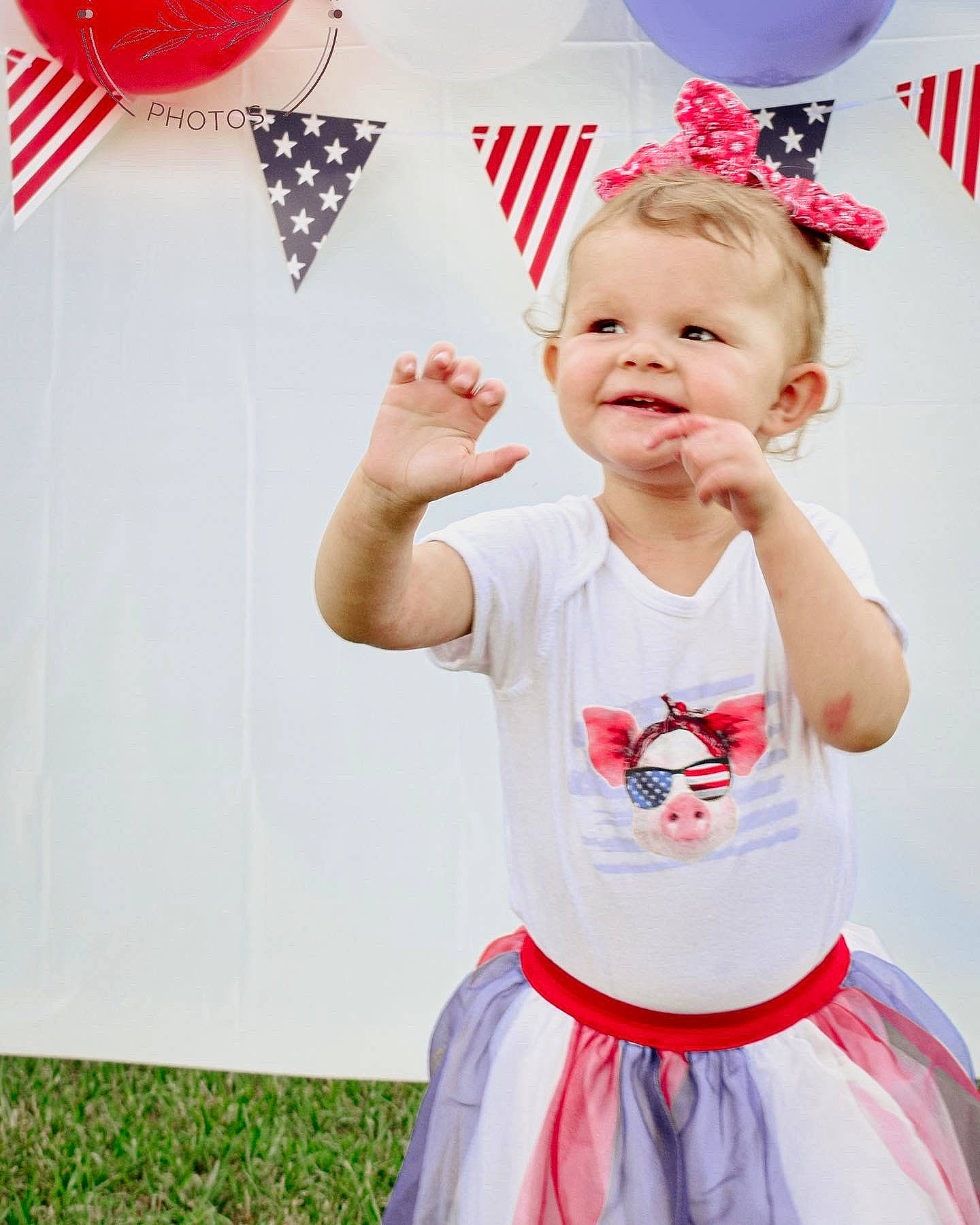 Maylie is registered to the contest to win money with this photo: baby, baby_toddler_clothing, balloon, child, event, fun, gesture, happy, head, joy, magenta, party_supply, pattern, person, photograph, pink, red, sleeve, smile, t_shirt