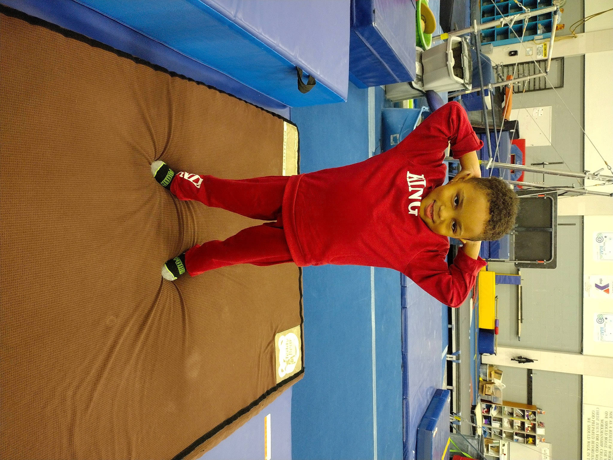 Major is registered to the contest to win money with this photo: balance, building, carmine, elbow, electric_blue, flooring, hat, human_leg, joy, knee, orange, person, recreation, room, shorts, sneakers, sportswear, thigh, walking_shoe