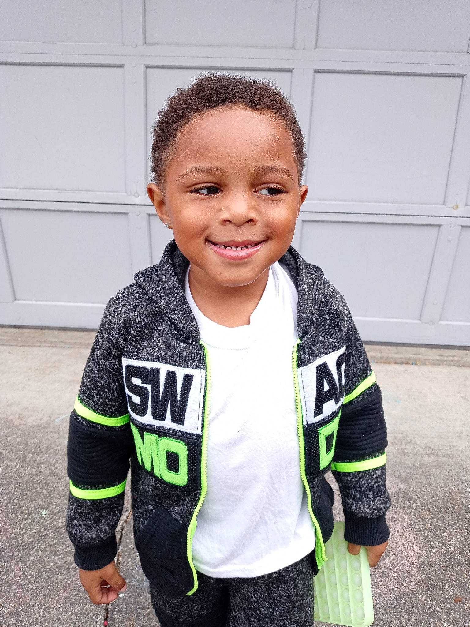 Major is registered to the contest to win money with this photo: baby_toddler_clothing, child, flooring, fun, happy, head, jersey, joy, nose, person, personal_protective_equipment, play, sleeve, smile, sportswear, street_fashion, style, t_shirt, thumb, toddler