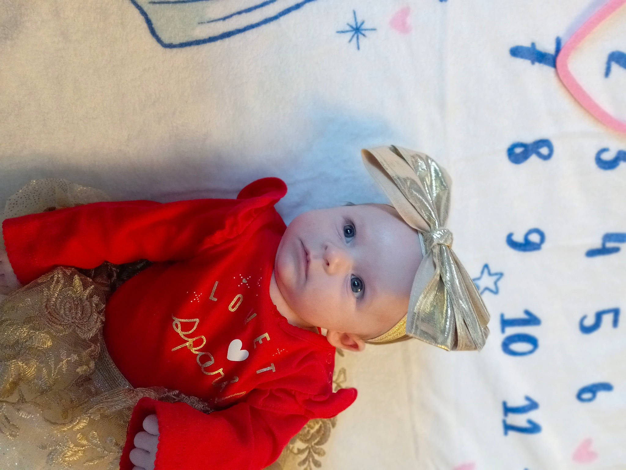 Londyn is registered to the contest to win money with this photo: baby, baby_toddler_clothing, child, costume_hat, event, fun, happy, hat, headwear, linens, pattern, person, sleeve, smile, toddler