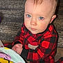 toddler, child, baby, pajamas, red, black, plaid, floor, carpet, blanket, smiley_faces, indoor, person, face, blue_eyes, kneeling, hands_together, cute, curious, home