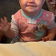 Talylah joined the competition — help win amazing prizes! baby, child, smiling, waving, indoors, carpet, onesie, cartoon_character, person, happy, infant, cute, face, hand, sitting, background, bag, fabric, floor, young