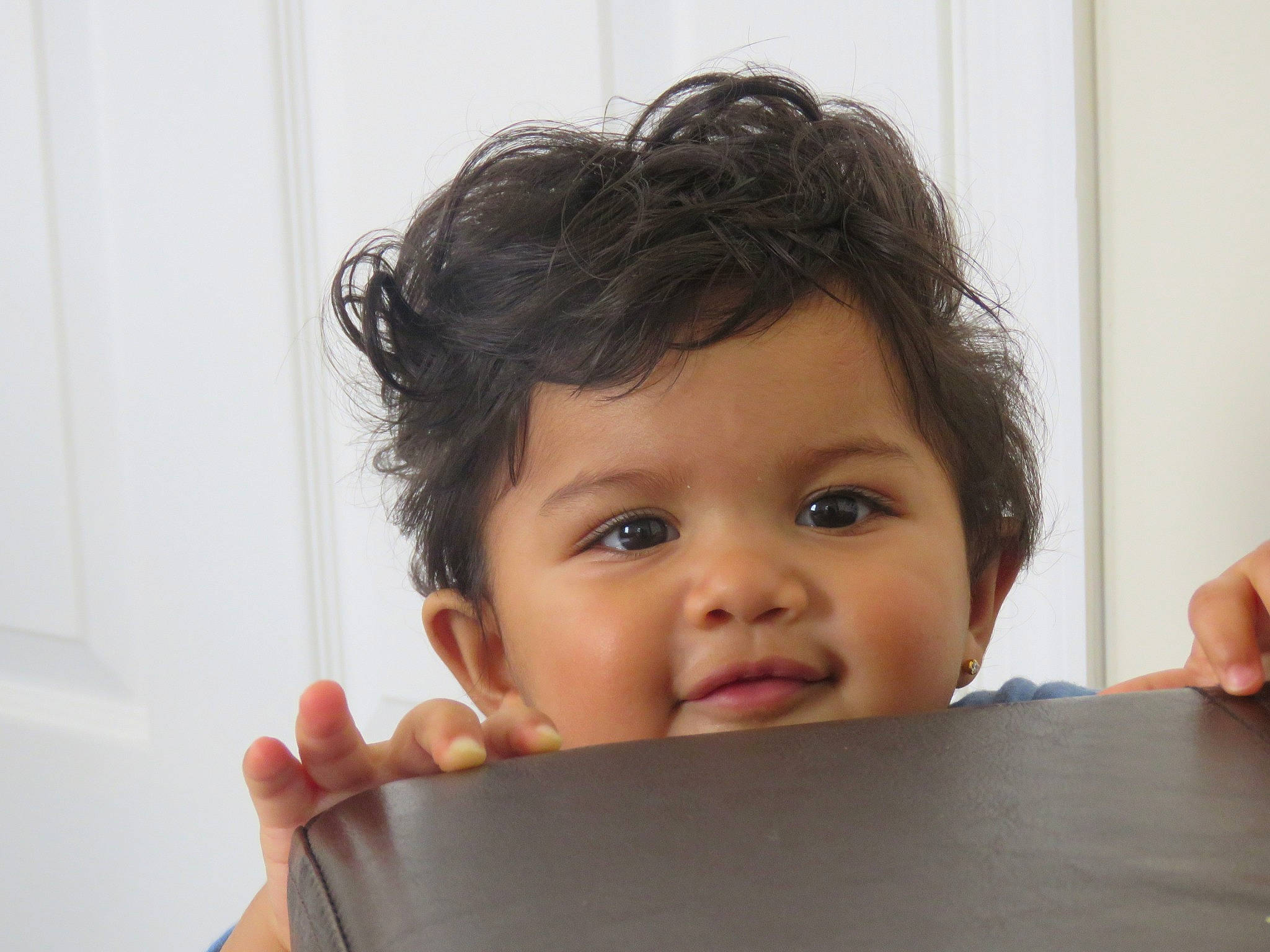 Jenelle is registered to the contest to win money with this photo: baby, black_hair, cheek, child, chin, ear, face, finger, forehead, gesture, hair, hairstyle, hand, head, human, lip, mouth, nose, person, skin