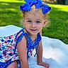 child, toddler, girl, blue_bows, dress, smile, face, outdoor, grass, blanket, summer, cute, portrait, happy, sitting, young_child, nature, daylight, innocence, playful