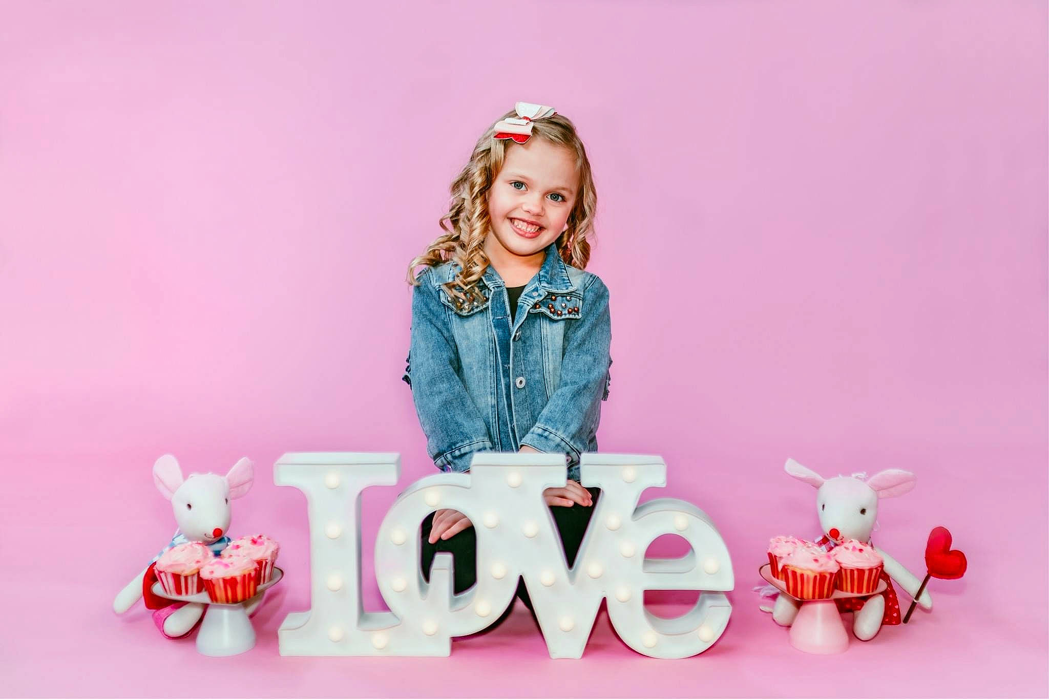 Lillian is registered to the contest to win money with this photo: baby_toddler_clothing, child, coffee_cup, event, facial_expression, font, happy, joy, magenta, pattern, peach, person, pink, purple, sitting, sleeve, smile, stuffed_toy, sweetness, teddy_bear